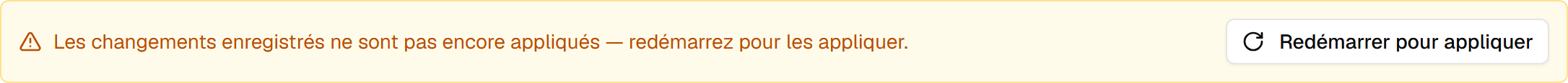 La bannière ambre « Les changements enregistrés ne sont pas encore appliqués - redémarrez pour les appliquer », avec un bouton Redémarrer pour appliquer à côté.